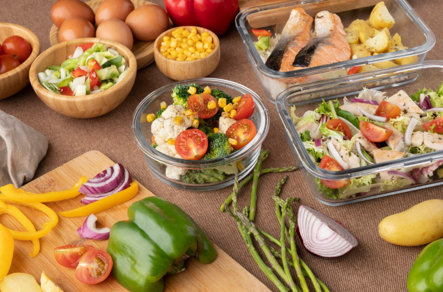 meal prep containers and ingredients for a cook once eat all week routine