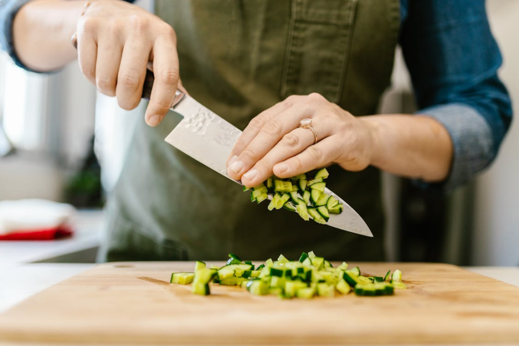 chopping vegetables with a chef’s knife illustrating time saving kitchen tools for easier meal prep