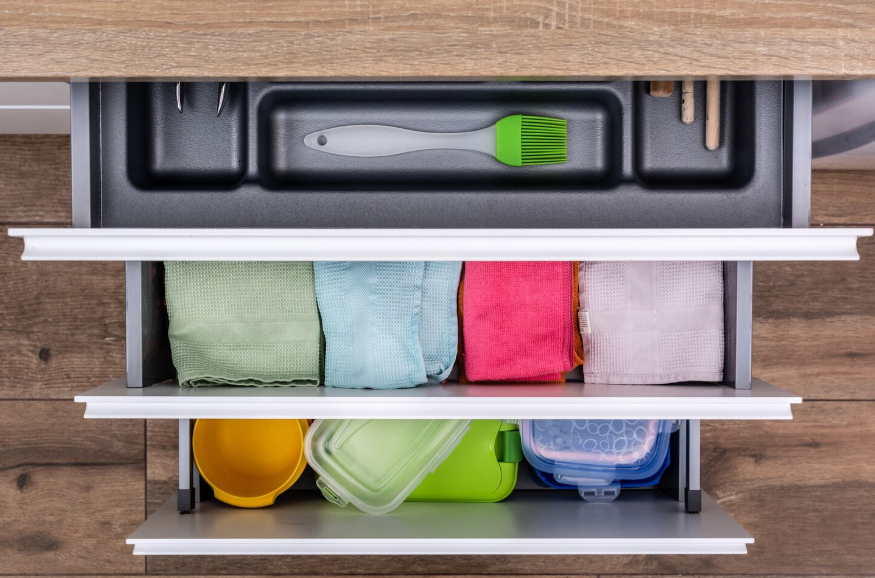 organized kitchen drawer and storage containers showing kitchen organization hacks for easier cooking