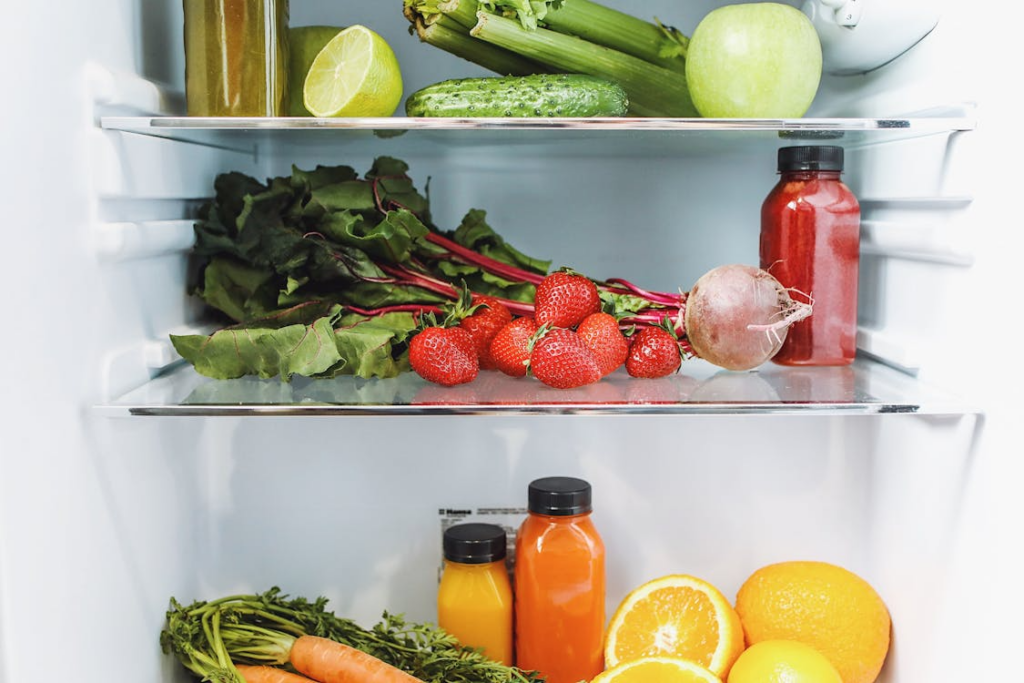 fresh fruits and vegetables stored in a fridge using the best ways to store fresh produce