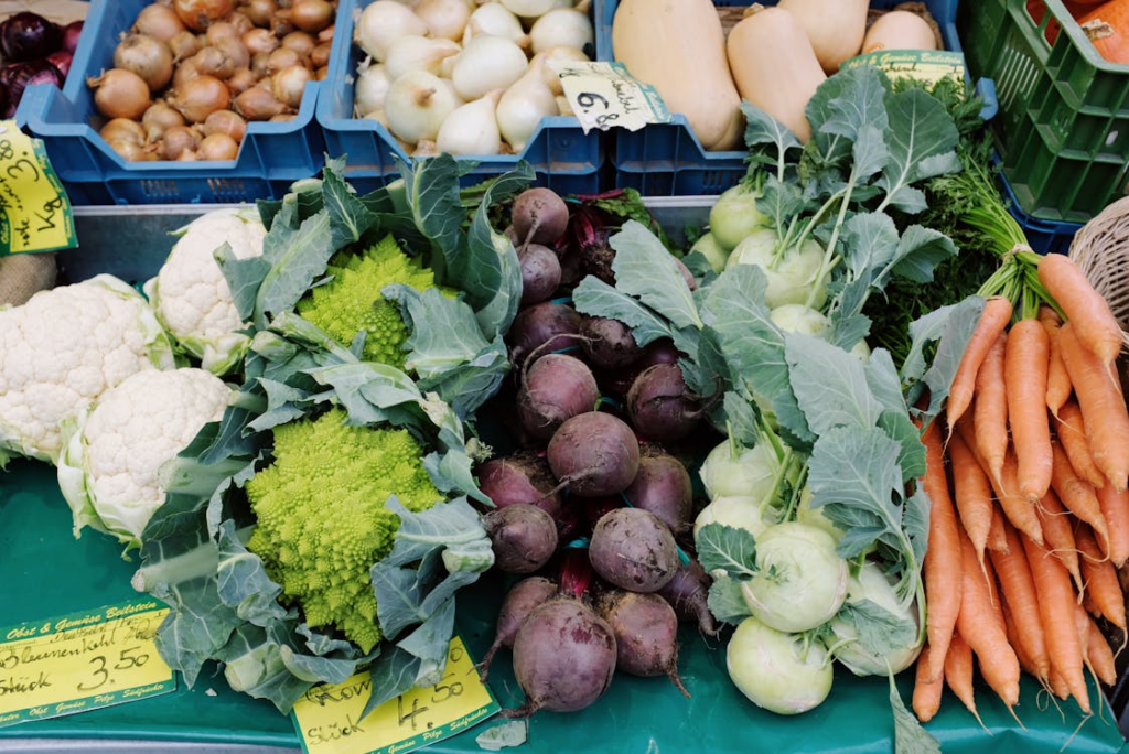 fresh vegetables at a market showing what to buy organic and what to skip for smarter grocery shopping